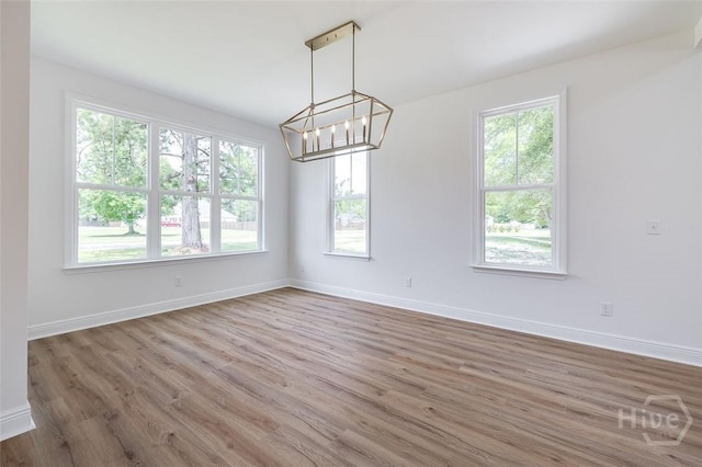 201 Dean Dr, Guyton, GA 31312 - spare room featuring healthy amount of natural light, wood finished floors, and a chandelier