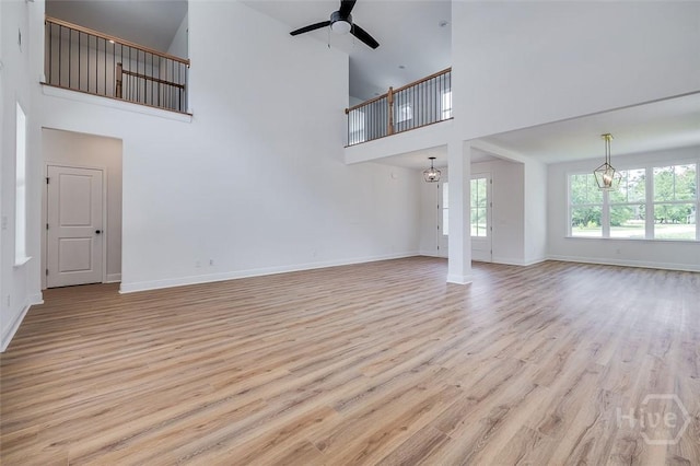 201 Dean Dr, Guyton, GA 31312 - unfurnished living room with a towering ceiling, a ceiling fan, and wood finished floors