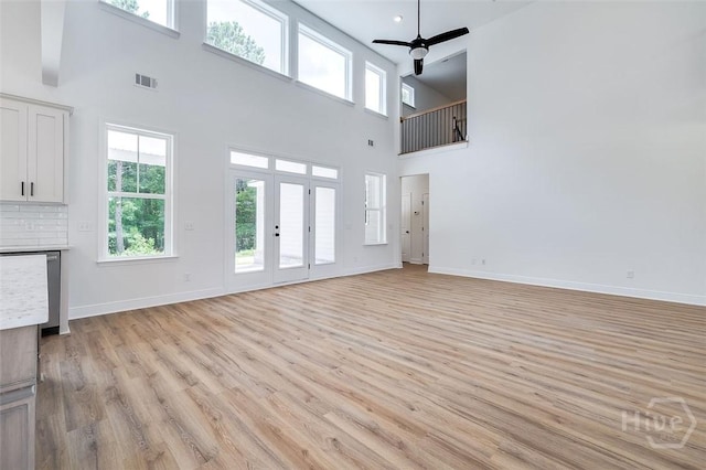 201 Dean Dr, Guyton, GA 31312 - unfurnished living room featuring a high ceiling, a ceiling fan, and light wood-style flooring