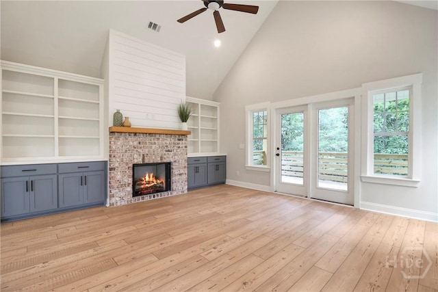 178 Cubbedge Dr, Rincon, GA 31326 - unfurnished living room with light wood finished floors, ceiling fan, plenty of natural light, high vaulted ceiling, and a fireplace