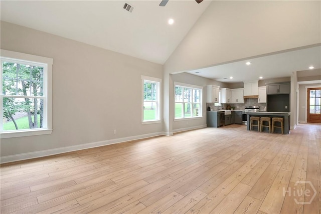 178 Cubbedge Dr, Rincon, GA 31326 - unfurnished living room featuring light wood-style flooring, ceiling fan, high vaulted ceiling, and recessed lighting