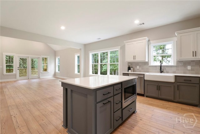 178 Cubbedge Dr, Rincon, GA 31326 - kitchen with appliances with stainless steel finishes, gray cabinetry, open floor plan, light countertops, and light wood-style floors