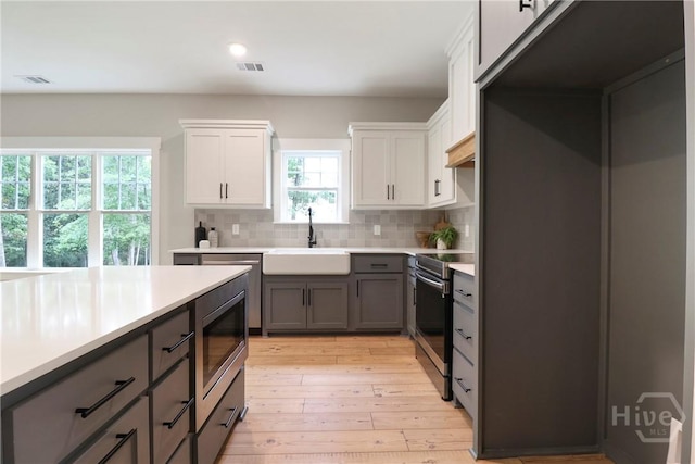178 Cubbedge Dr, Rincon, GA 31326 - kitchen featuring appliances with stainless steel finishes, backsplash, light countertops, gray cabinets, and light wood-style flooring