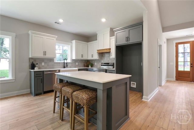 178 Cubbedge Dr, Rincon, GA 31326 - kitchen with appliances with stainless steel finishes, backsplash, light countertops, light wood finished floors, and recessed lighting