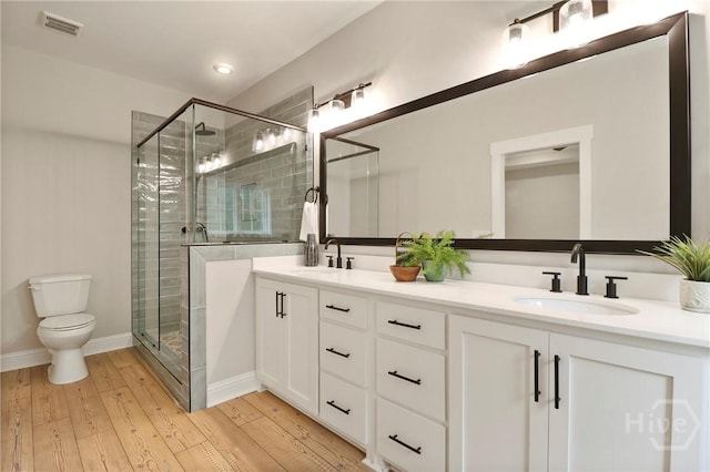 178 Cubbedge Dr, Rincon, GA 31326 - bathroom featuring double vanity, a stall shower, and wood-type flooring