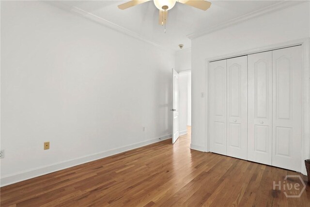 271 Davis Rd, Richmond Hill, GA 31324 - unfurnished bedroom with ornamental molding, wood finished floors, a closet, and a ceiling fan