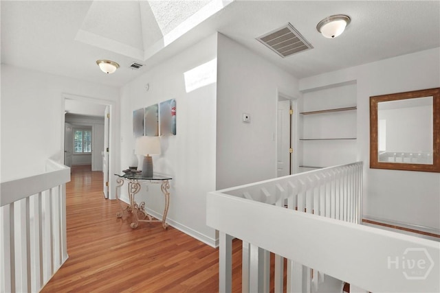 271 Davis Rd, Richmond Hill, GA 31324 - hallway featuring light wood finished floors and a skylight