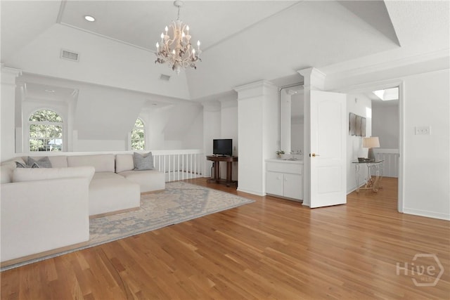 271 Davis Rd, Richmond Hill, GA 31324 - living room with light wood-style flooring, vaulted ceiling, a chandelier, and recessed lighting
