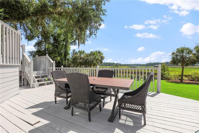 271 Davis Rd, Richmond Hill, GA 31324 - deck with outdoor dining area, a lawn, and stairs