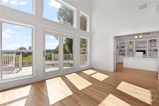 271 Davis Rd, Richmond Hill, GA 31324 - doorway to outside featuring a high ceiling, wood finished floors, and ceiling fan