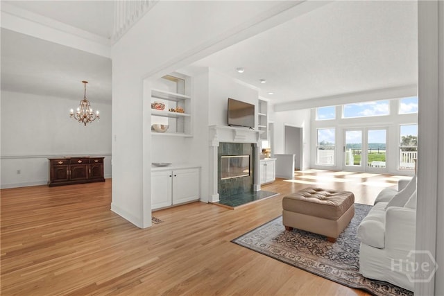 271 Davis Rd, Richmond Hill, GA 31324 - living room with a fireplace, light wood-type flooring, a chandelier, and built in features
