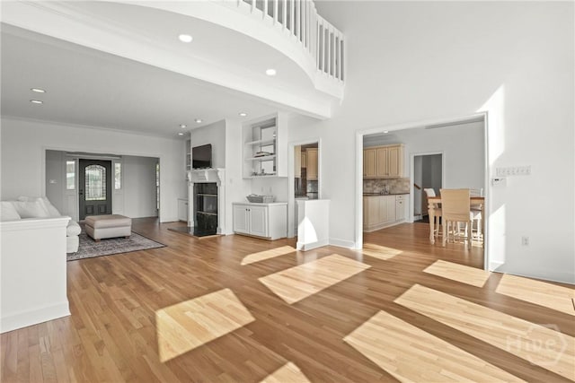 271 Davis Rd, Richmond Hill, GA 31324 - unfurnished living room featuring light wood-style flooring, recessed lighting, and a glass covered fireplace