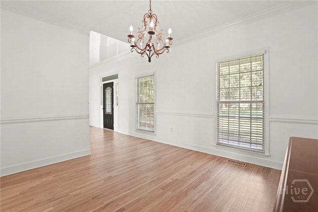 271 Davis Rd, Richmond Hill, GA 31324 - unfurnished dining area featuring a chandelier, plenty of natural light, wood finished floors, and ornamental molding