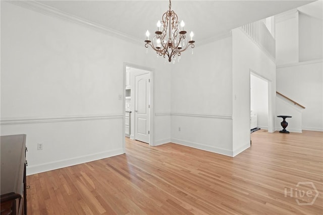 271 Davis Rd, Richmond Hill, GA 31324 - unfurnished dining area featuring a chandelier, crown molding, and light wood-style flooring