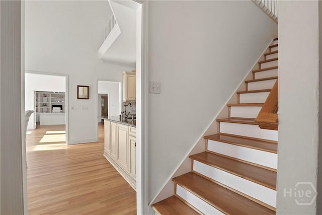 271 Davis Rd, Richmond Hill, GA 31324 - staircase featuring wood finished floors and a towering ceiling