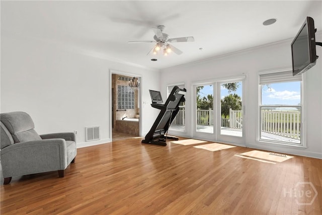 271 Davis Rd, Richmond Hill, GA 31324 - workout room with wood finished floors, a ceiling fan, and crown molding