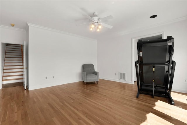 271 Davis Rd, Richmond Hill, GA 31324 - unfurnished room featuring crown molding, a ceiling fan, wood finished floors, and stairs