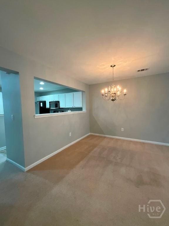 230 Opus Ct, Pooler, GA 31322 - unfurnished room with light colored carpet and a chandelier