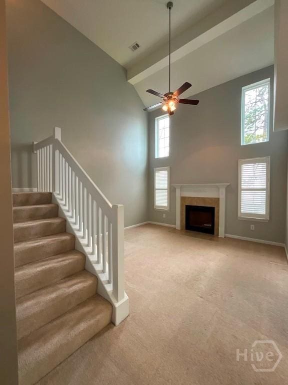 230 Opus Ct, Pooler, GA 31322 - unfurnished living room featuring high vaulted ceiling, carpet flooring, a ceiling fan, stairs, and a fireplace with flush hearth