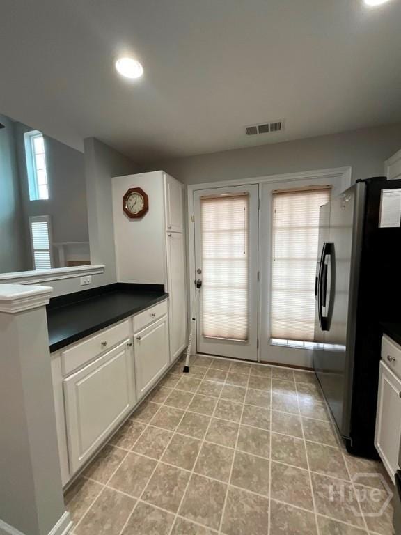 230 Opus Ct, Pooler, GA 31322 - kitchen featuring freestanding refrigerator, dark countertops, white cabinetry, light tile patterned flooring, and recessed lighting