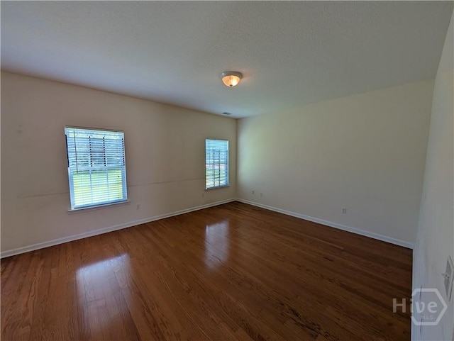 10 Evergreen Oak Dr, Richmond Hill, GA 31324 - empty room featuring dark wood finished floors and baseboards