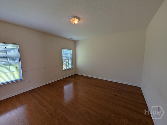10 Evergreen Oak Dr, Richmond Hill, GA 31324 - empty room with dark wood finished floors