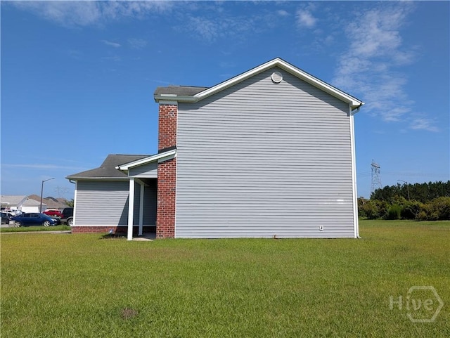 10 Evergreen Oak Dr, Richmond Hill, GA 31324 - view of home's exterior with a lawn and a chimney