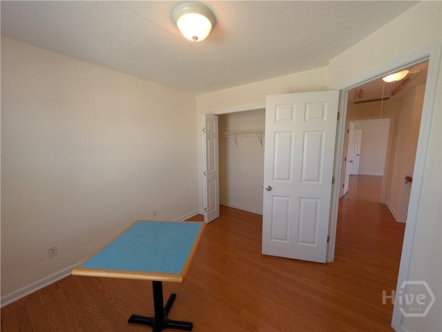10 Evergreen Oak Dr, Richmond Hill, GA 31324 - unfurnished bedroom featuring wood finished floors, a closet, and attic access