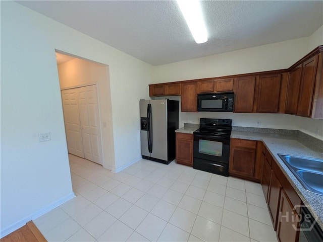 10 Evergreen Oak Dr, Richmond Hill, GA 31324 - kitchen with black appliances, a textured ceiling, and light tile patterned floors