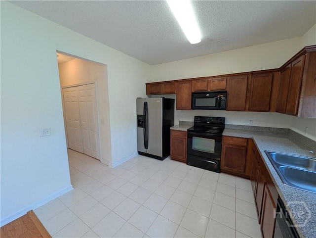 10 Evergreen Oak Dr, Richmond Hill, GA 31324 - kitchen with black appliances, a textured ceiling, and light tile patterned floors