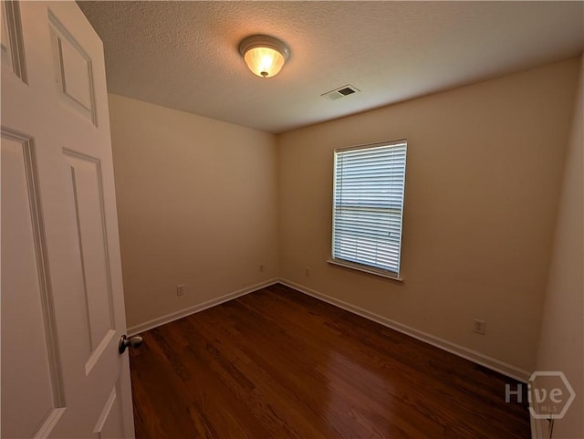 10 Evergreen Oak Dr, Richmond Hill, GA 31324 - unfurnished room with dark wood finished floors and a textured ceiling
