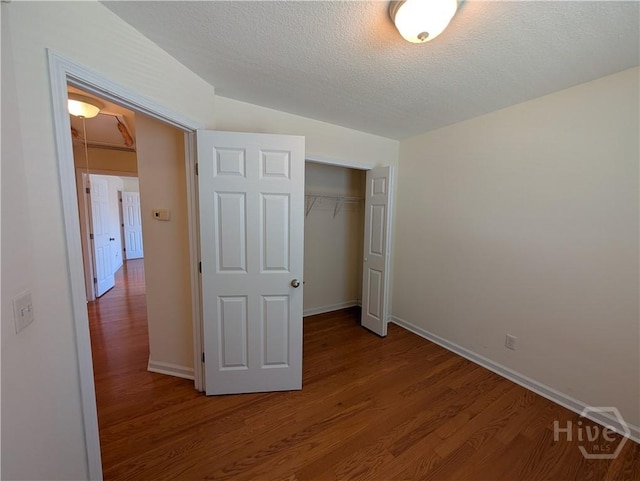 10 Evergreen Oak Dr, Richmond Hill, GA 31324 - unfurnished bedroom with wood finished floors, a closet, and a textured ceiling