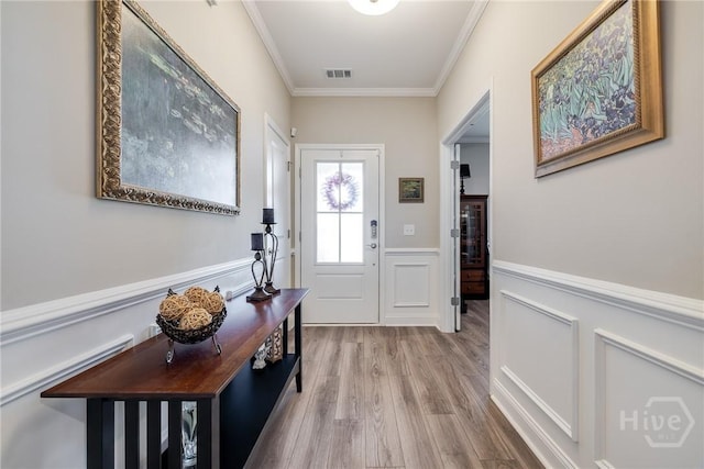 139 Harvest Hl, Pooler, GA 31322 - entryway featuring crown molding, wood finished floors, a wainscoted wall, and a decorative wall