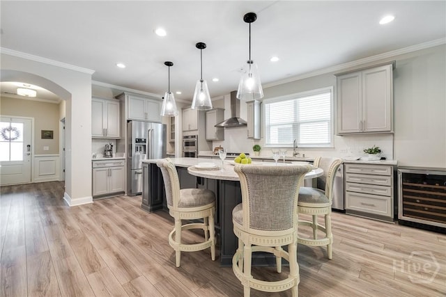 139 Harvest Hl, Pooler, GA 31322 - dining room featuring wine cooler, crown molding, arched walkways, light wood finished floors, and recessed lighting