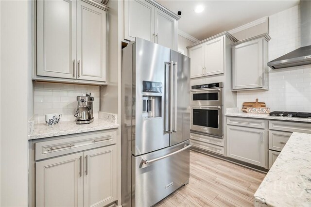 139 Harvest Hl, Pooler, GA 31322 - kitchen with appliances with stainless steel finishes, wall chimney range hood, tasteful backsplash, ornamental molding, and gray cabinetry