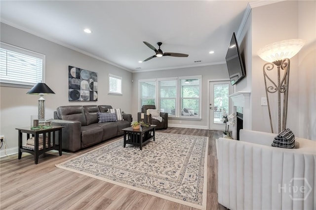 139 Harvest Hl, Pooler, GA 31322 - living room featuring light wood-style flooring, a ceiling fan, crown molding, recessed lighting, and a fireplace