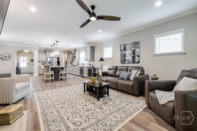 139 Harvest Hl, Pooler, GA 31322 - living room featuring ornamental molding, a ceiling fan, arched walkways, recessed lighting, and plenty of natural light