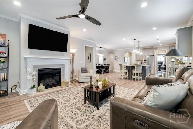 139 Harvest Hl, Pooler, GA 31322 - living room featuring light wood-style flooring, crown molding, recessed lighting, a ceiling fan, and a fireplace