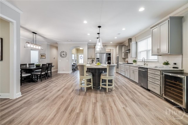 139 Harvest Hl, Pooler, GA 31322 - kitchen with wine cooler, stainless steel appliances, gray cabinets, ornamental molding, and wall chimney exhaust hood