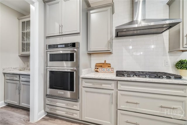 139 Harvest Hl, Pooler, GA 31322 - kitchen with wall chimney range hood, appliances with stainless steel finishes, gray cabinets, and ornamental molding