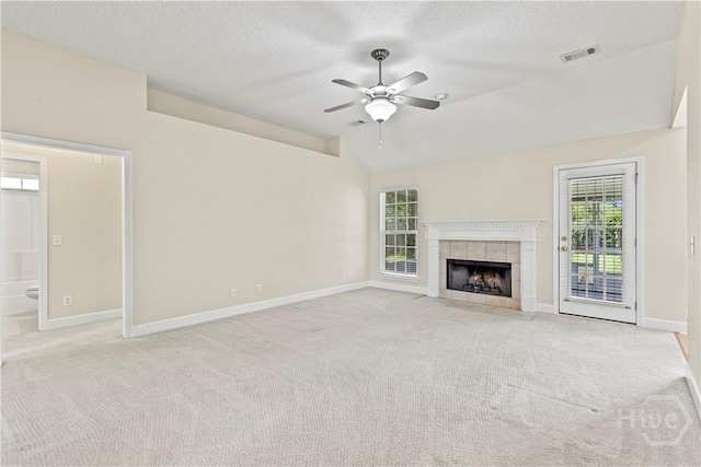 41 Patriot Dr, Richmond Hill, GA 31324 - unfurnished living room featuring carpet, ceiling fan, plenty of natural light, a fireplace, and a textured ceiling