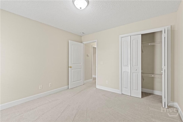 41 Patriot Dr, Richmond Hill, GA 31324 - unfurnished bedroom featuring a textured ceiling, a closet, and carpet flooring