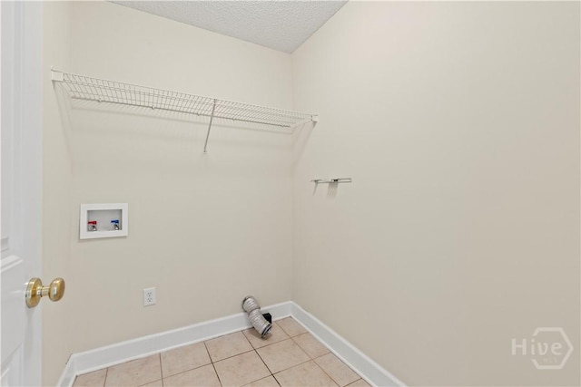 41 Patriot Dr, Richmond Hill, GA 31324 - laundry room featuring hookup for a washing machine, light tile patterned floors, and a textured ceiling