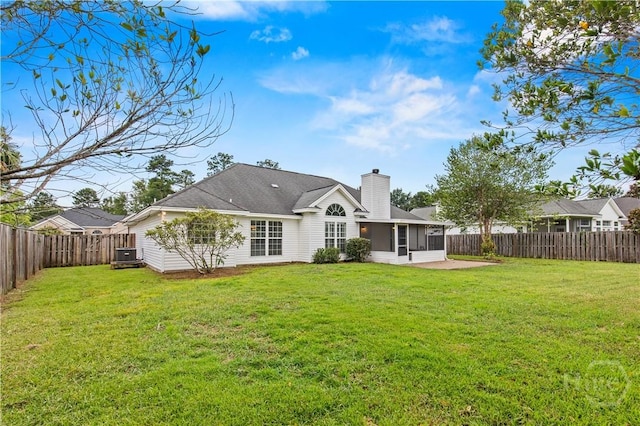41 Patriot Dr, Richmond Hill, GA 31324 - rear view of property featuring a sunroom, a fenced backyard, and a chimney