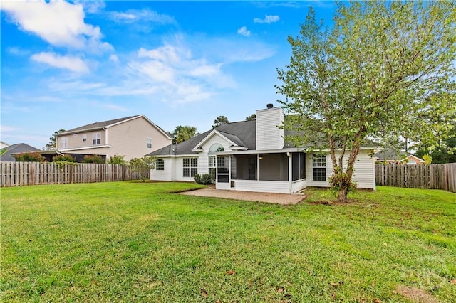 41 Patriot Dr, Richmond Hill, GA 31324 - back of house with a sunroom, a chimney, and a fenced backyard