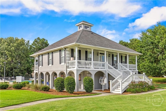 41 Patriot Dr, Richmond Hill, GA 31324 - view of front of home featuring a porch, stucco siding, roof with shingles, and stairs