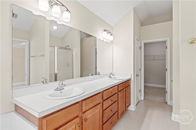 41 Patriot Dr, Richmond Hill, GA 31324 - full bath with a shower stall, double vanity, lofted ceiling, and a walk in closet