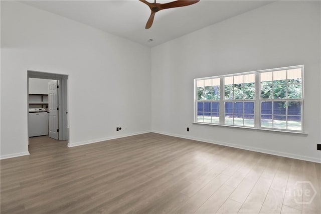 115 Yellow Jasmine Ct, Pooler, GA 31322 - spare room with healthy amount of natural light, a high ceiling, washer / clothes dryer, ceiling fan, and wood finished floors