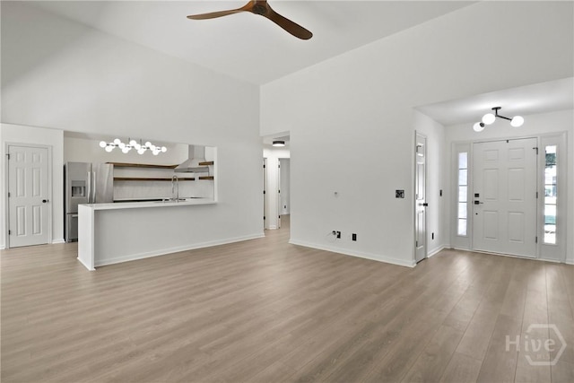 115 Yellow Jasmine Ct, Pooler, GA 31322 - unfurnished living room featuring a ceiling fan, light wood-style floors, and a towering ceiling