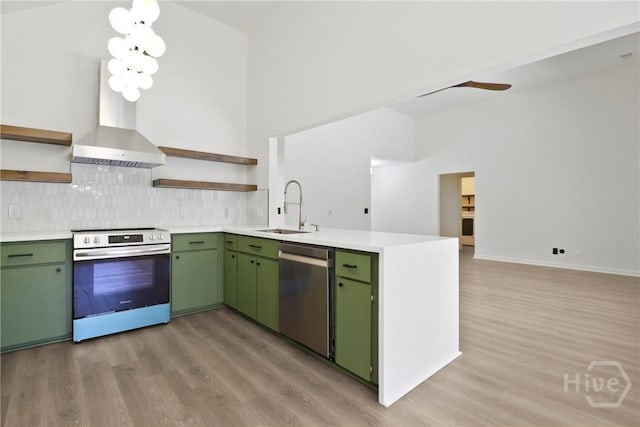115 Yellow Jasmine Ct, Pooler, GA 31322 - kitchen with appliances with stainless steel finishes, open shelves, green cabinetry, wall chimney exhaust hood, and light wood finished floors